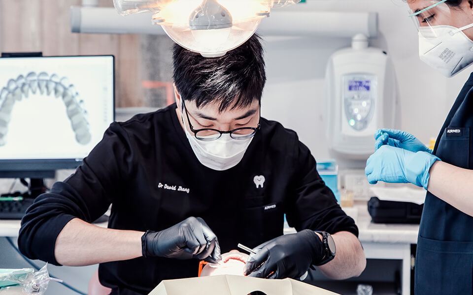 Dr. David Zhang examines an orthodontic patient at Blackburn Orthodontics
